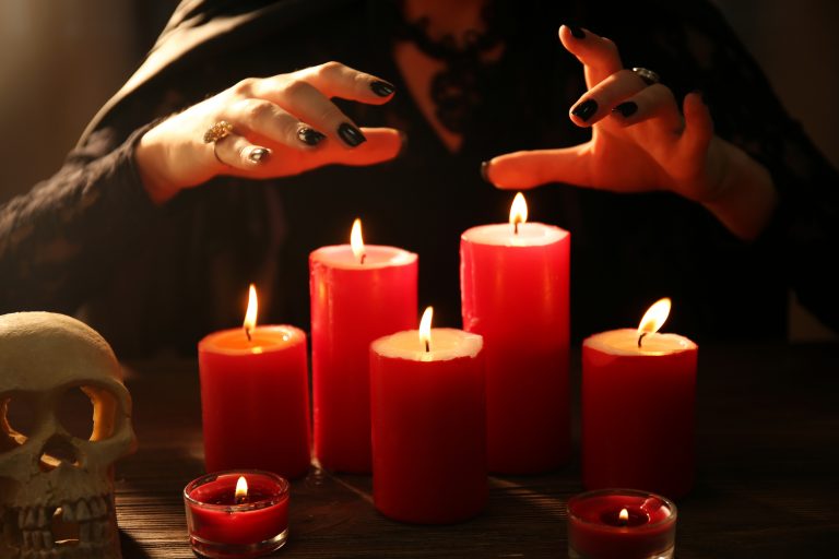 Witch - fortune teller with candles close up